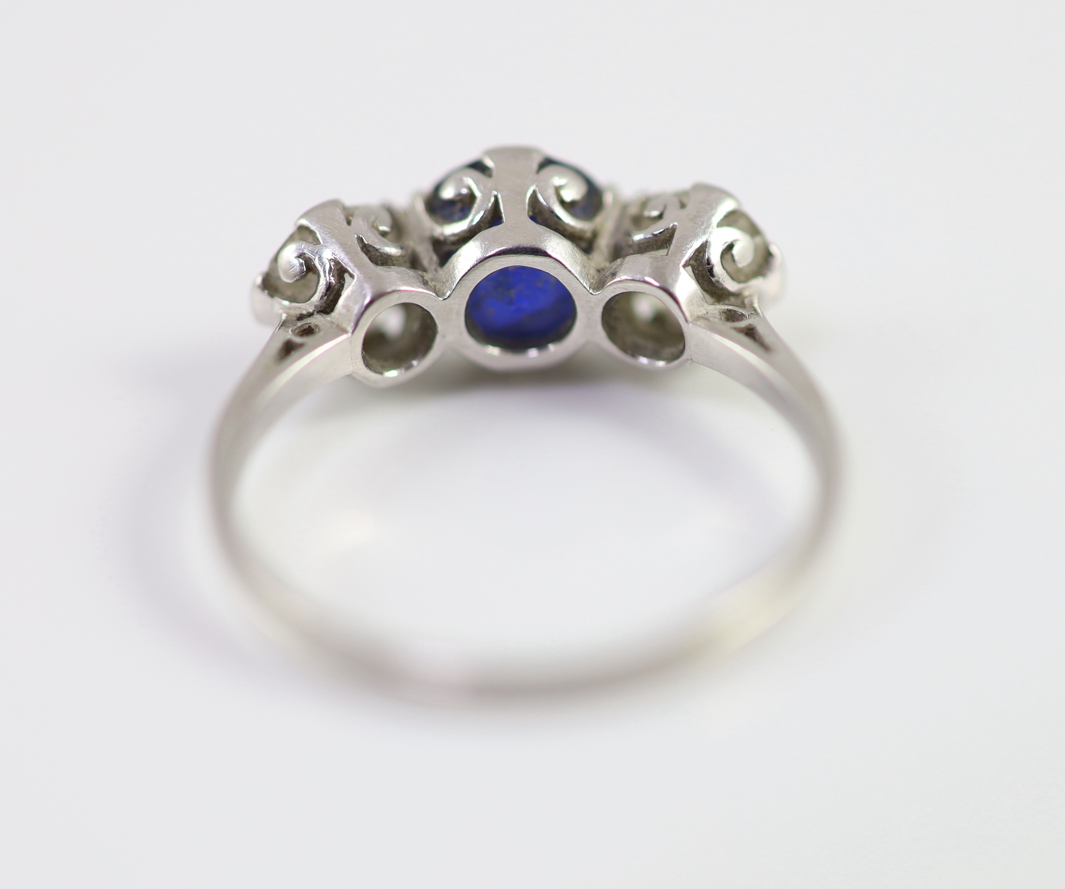 A platinum two stone diamond and single stone sapphire ring